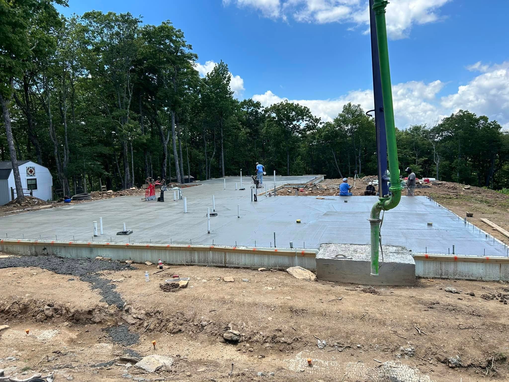 Large concrete slab project with crew finishing work on site